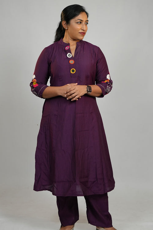 Woman wearing Aroha Amethyst plum co-ord set with arms crossed