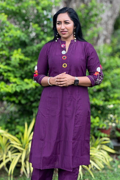 Woman wearing Aroha Amethyst plum co-ord set, front view