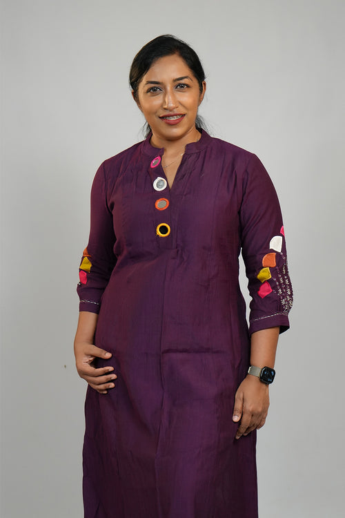 Woman wearing Aroha Amethyst plum co-ord set in a minimal queen pose