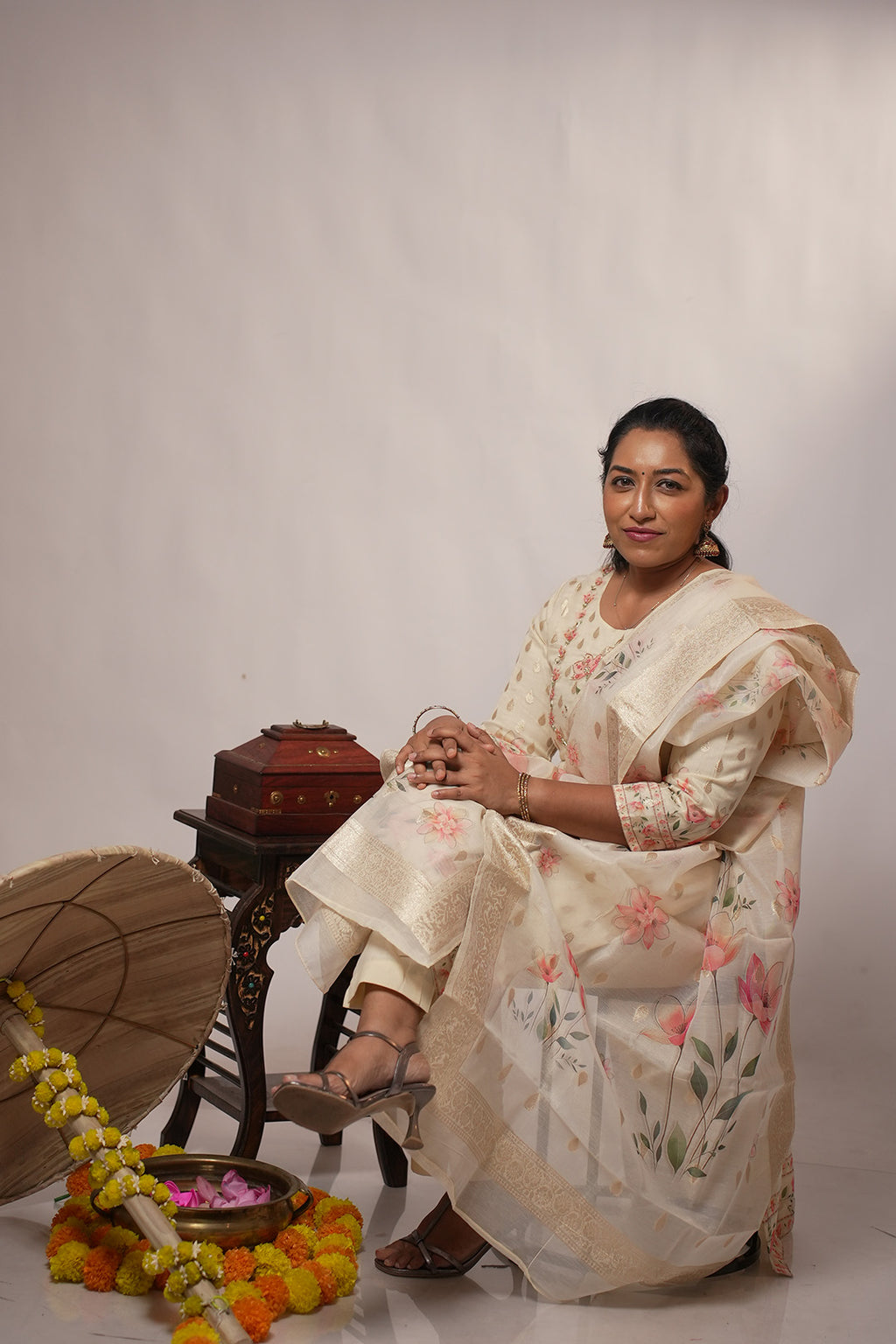 Woman seated wearing Aroha Blush Petals co-ord set