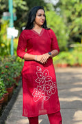 Woman wearing Aroha Crimson Muse red co-ord set, front view