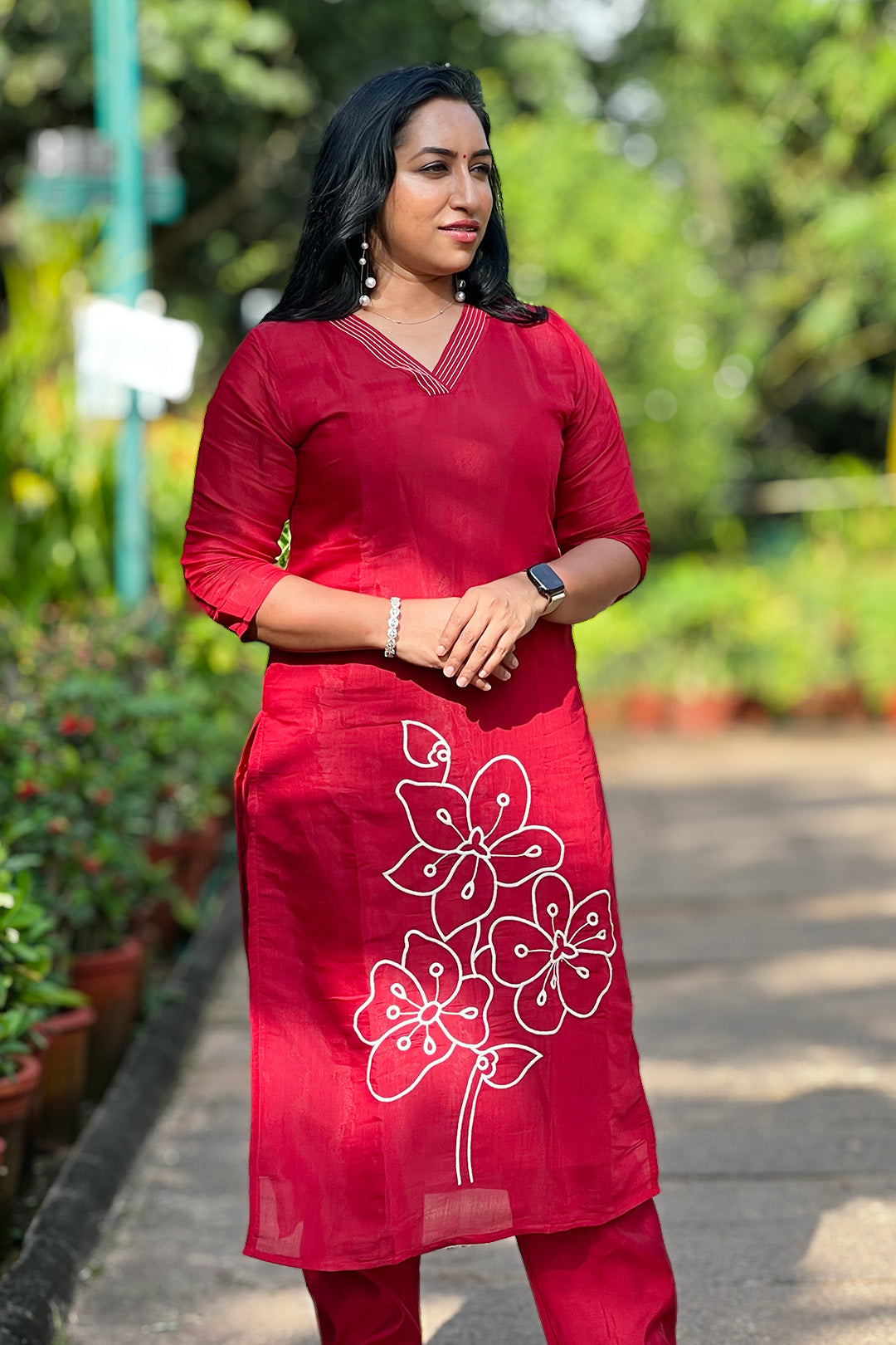 Woman wearing Aroha Crimson Muse red co-ord set, front view