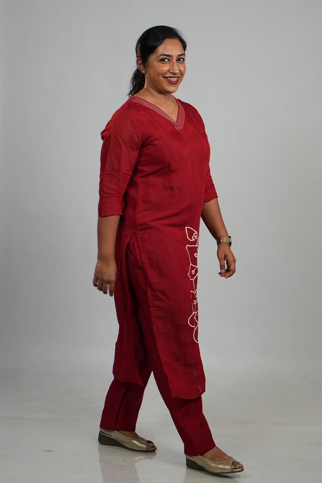 Woman walking candidly in Aroha Crimson Muse red co-ord set