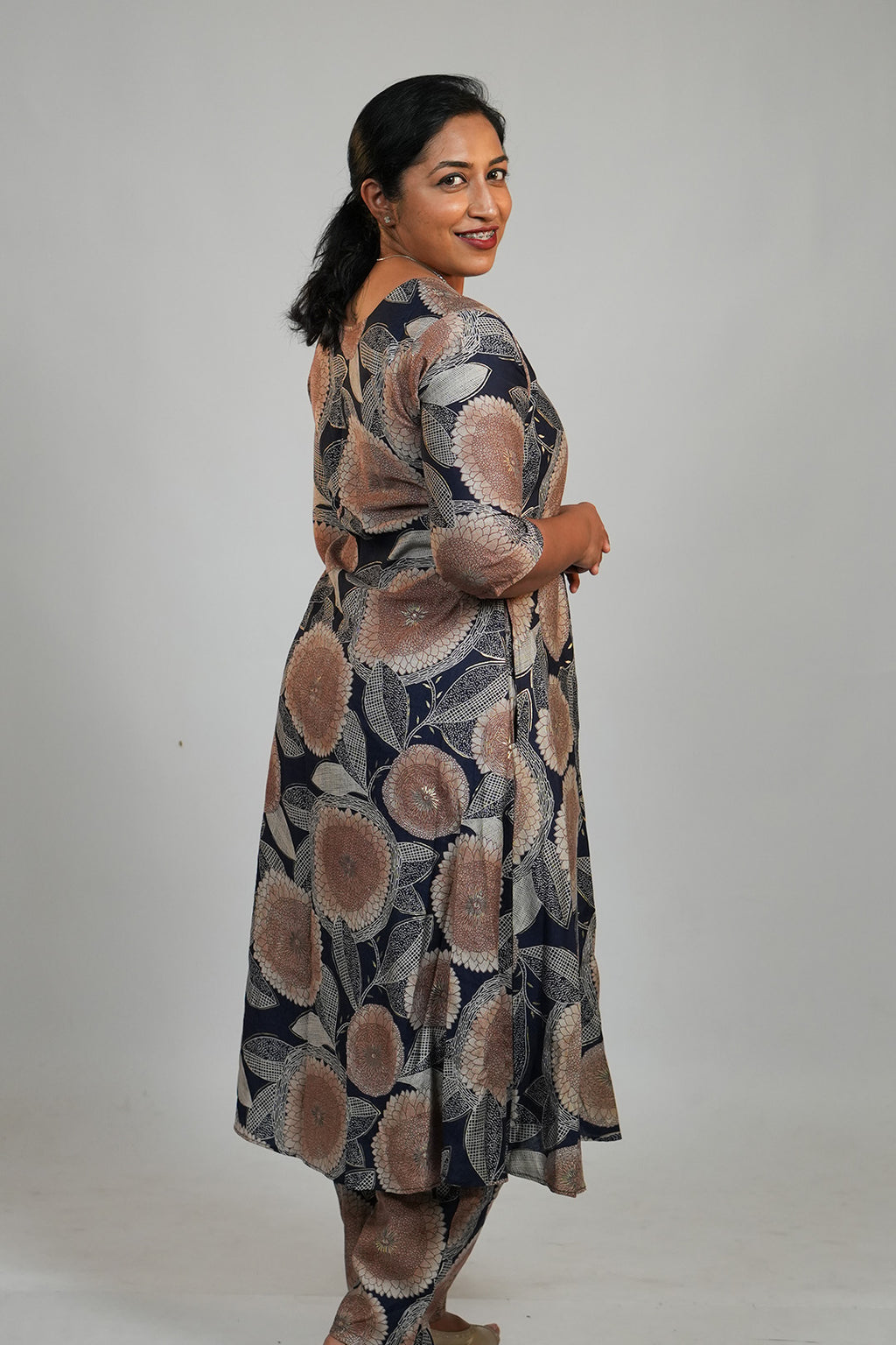 Woman in Aroha Dahlia navy co-ord set posing with an over the shoulder look