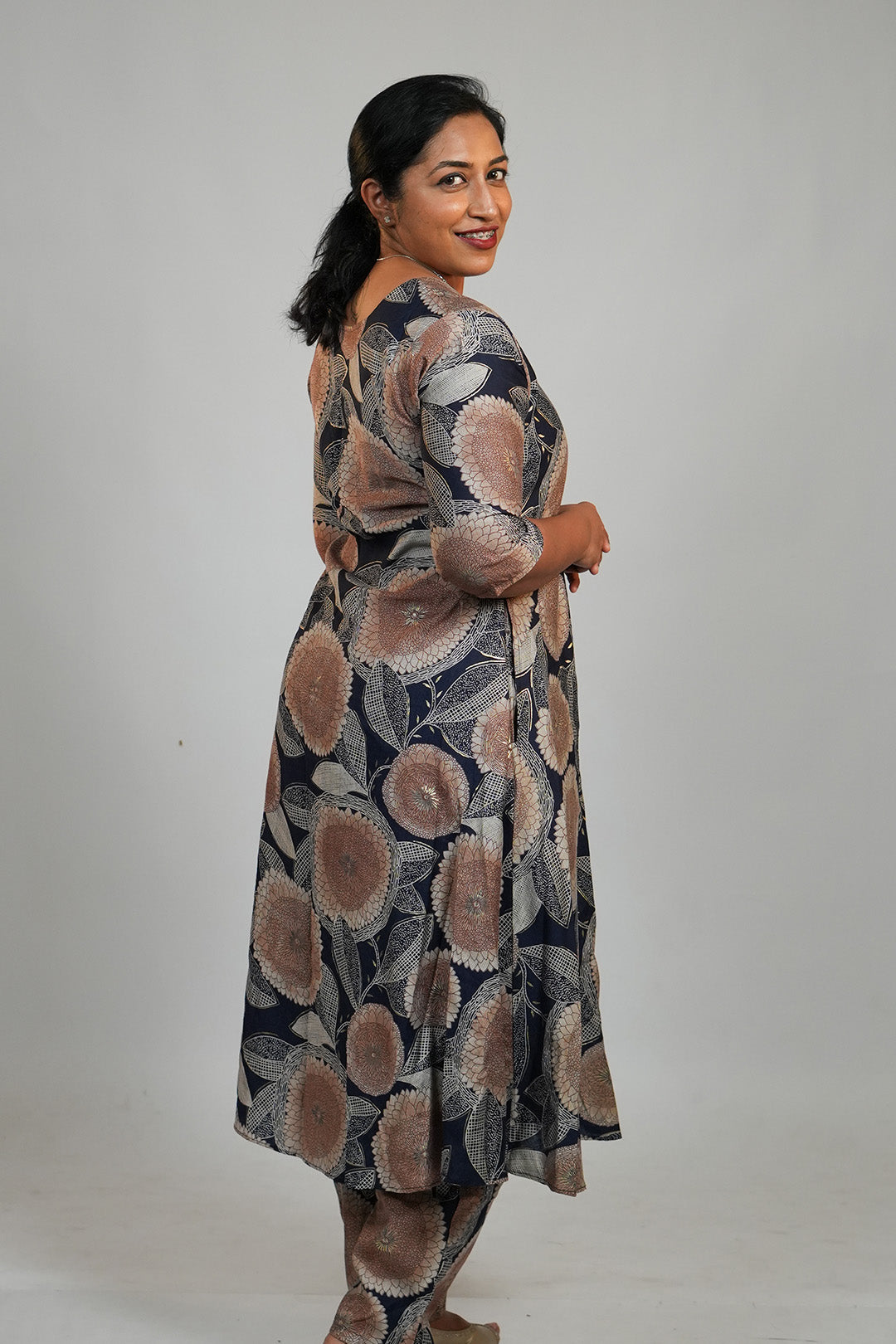 Woman in Aroha Dahlia navy co-ord set posing with an over the shoulder look