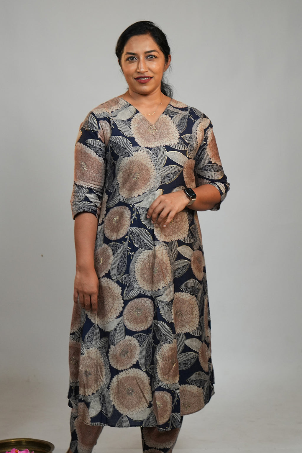 Woman standing in Aroha Dahlia navy co-ord set with botanical print
