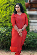 Woman wearing Aroha Ember Leaf terracotta co-ord set, front view