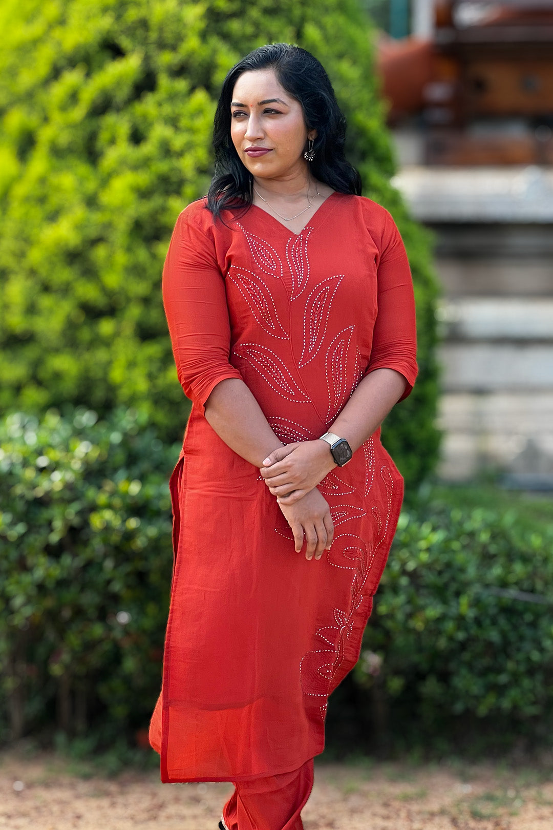 Woman wearing Aroha Ember Leaf terracotta co-ord set, front view