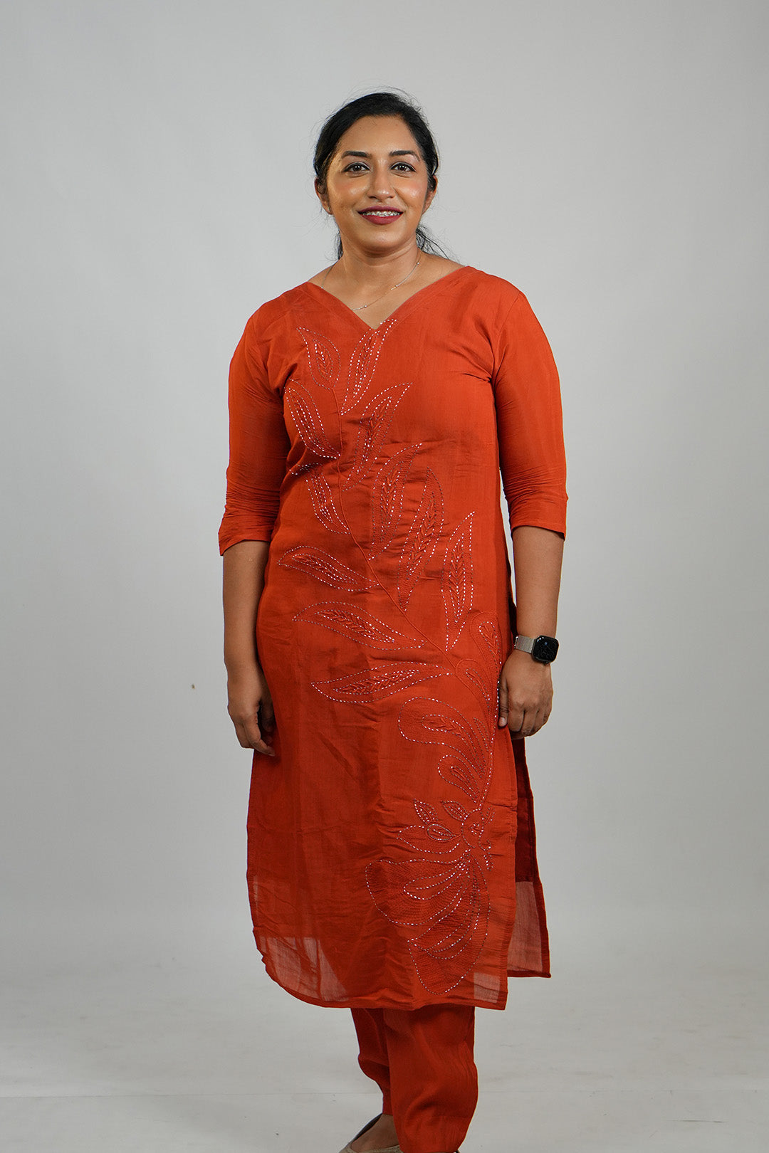 Woman standing in Aroha Ember Leaf terracotta co-ord set