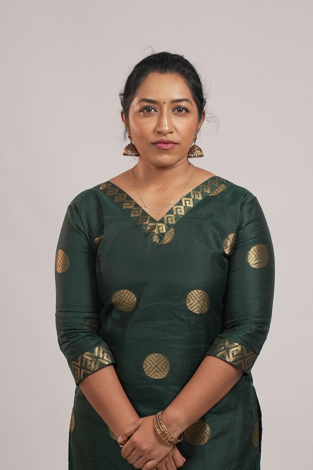 Woman wearing Aroha Emerald Grace green co-ord set with arms crossed