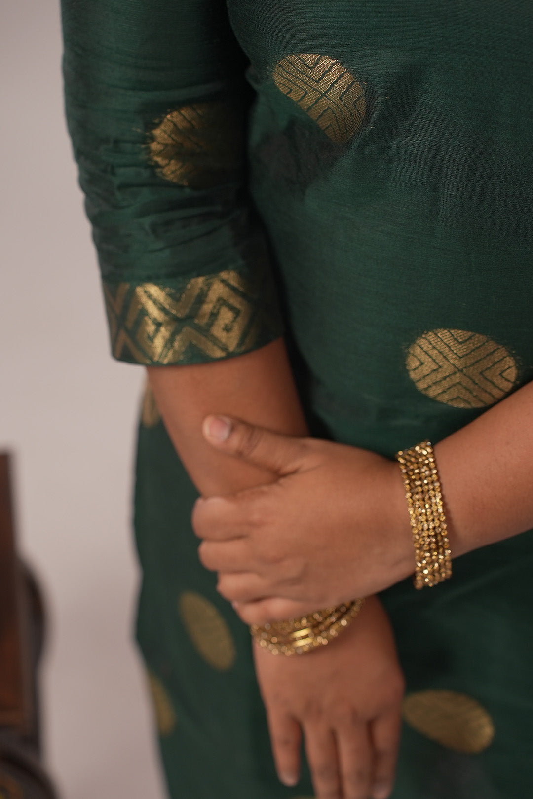 Close up of woman wearing Aroha Emerald Grace co-ord set with arms crossed