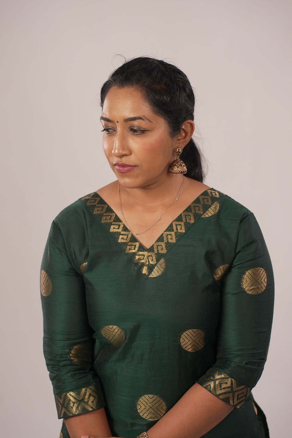 Woman in Aroha Emerald Grace co-ord set looking down, showing the kurti neckline