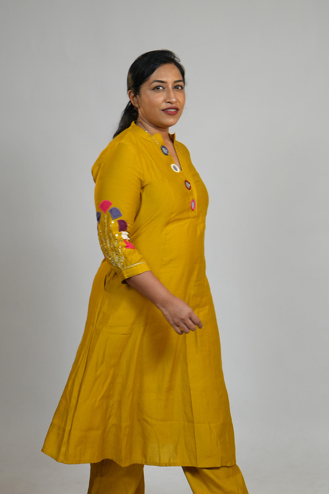 Woman walking candidly in Aroha Mustard Muse co-ord set