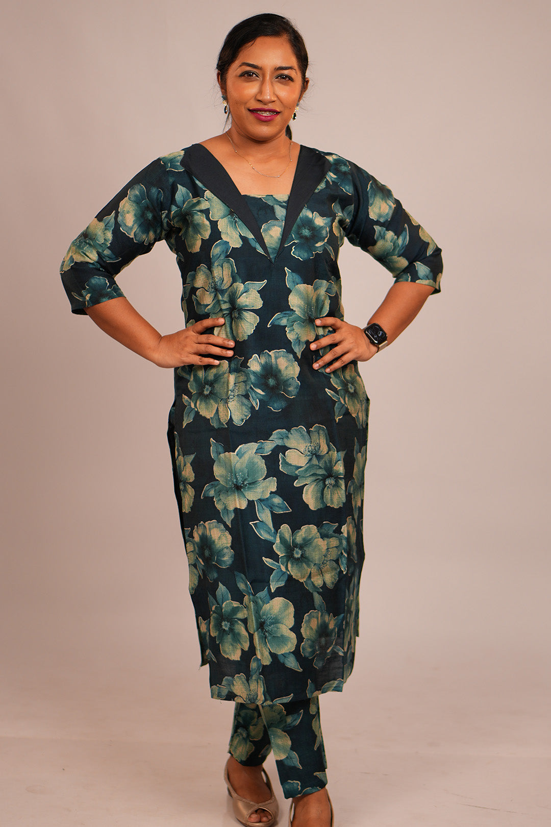 Woman in Aroha Oceanic Bloom teal co-ord set posing with hands on waist