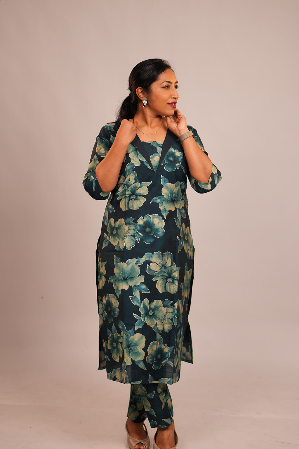 Woman in Aroha Oceanic Bloom teal co-ord set looking away