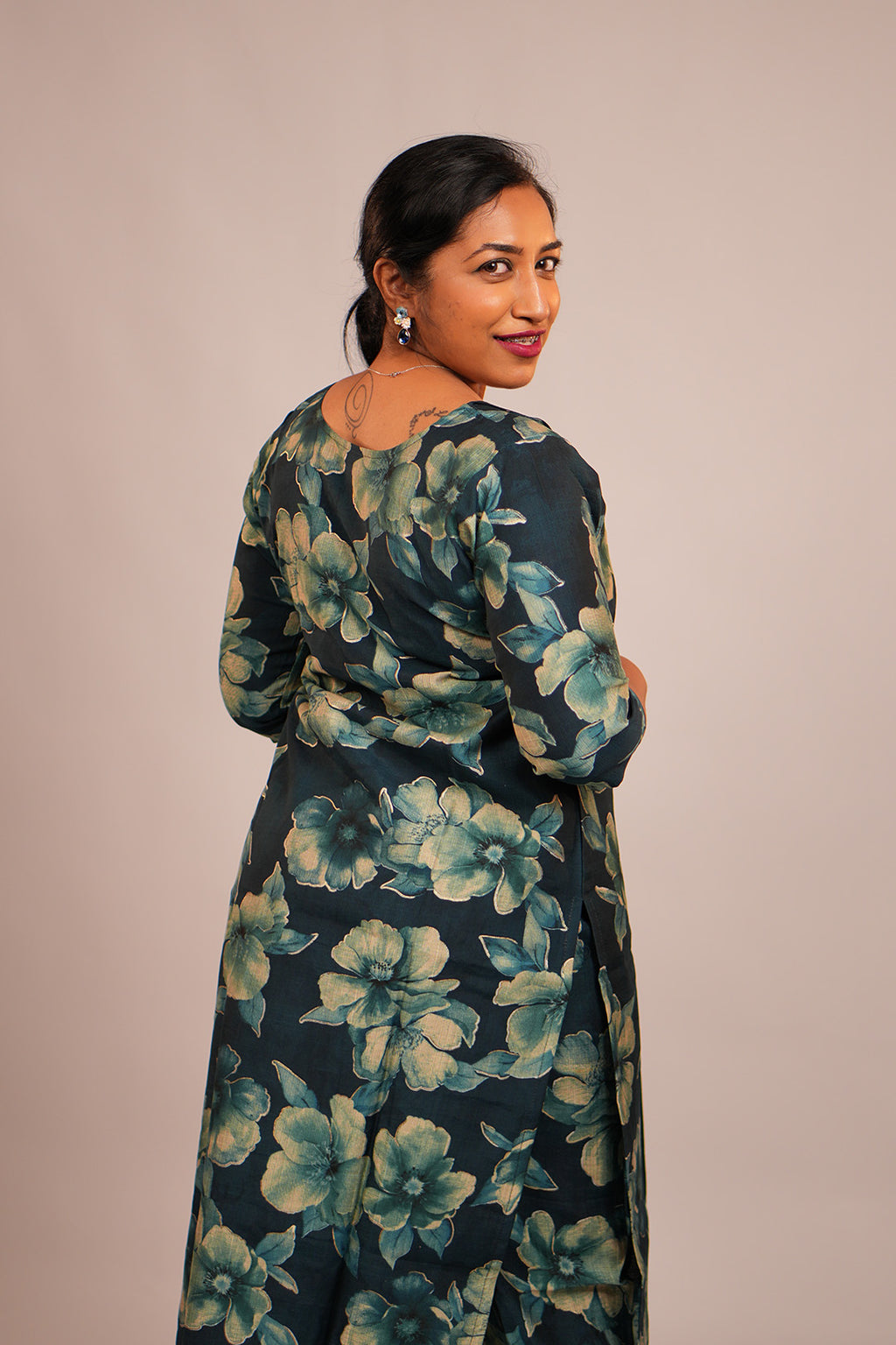 Woman in Aroha Oceanic Bloom co-ord set posing with an over the shoulder look