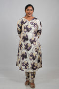 Woman in Aroha Orchid Muse co-ord set standing with hands clasped behind her back