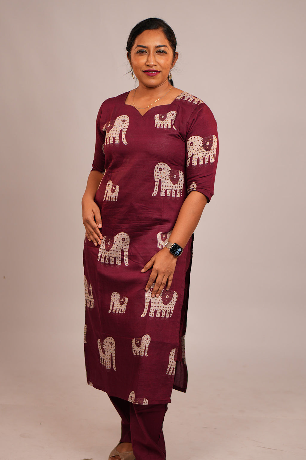 Woman standing in Aroha Ruby Elephant maroon co-ord set