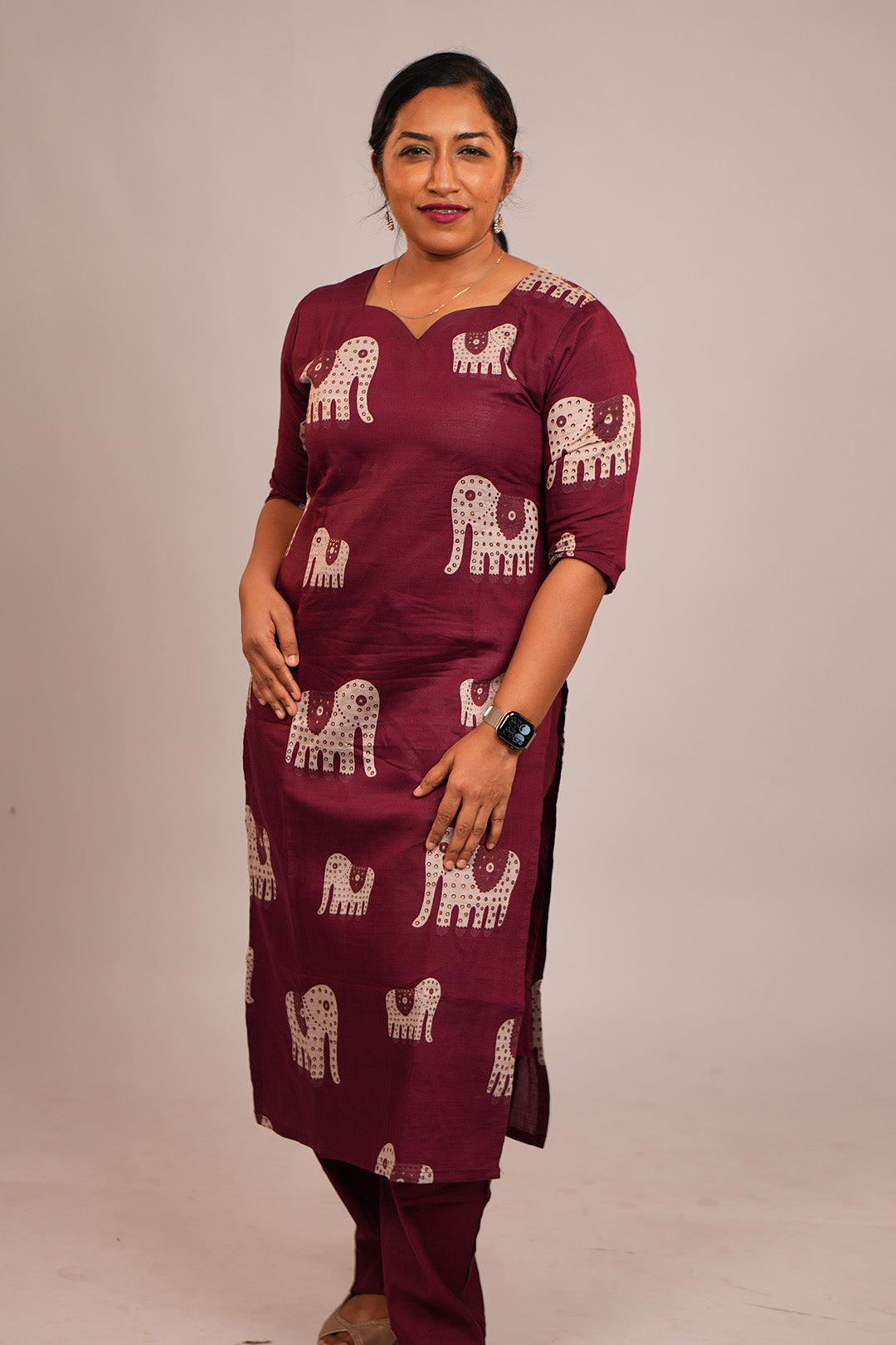 Woman standing in Aroha Ruby Elephant maroon co-ord set
