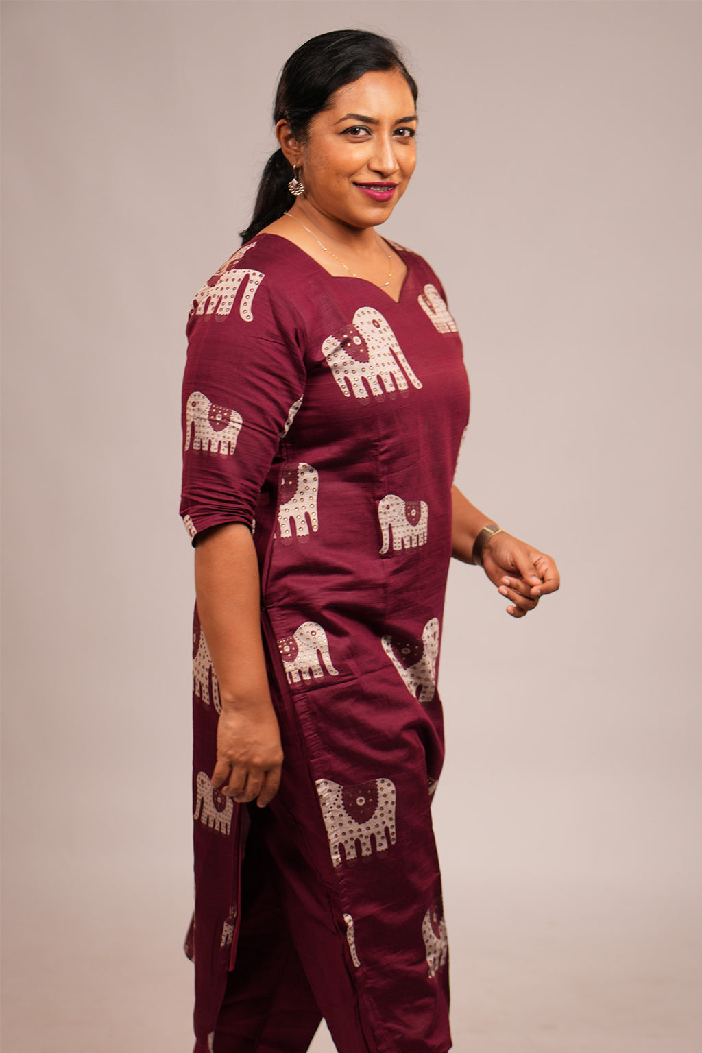 Woman walking candidly in Aroha Ruby Elephant maroon co-ord set