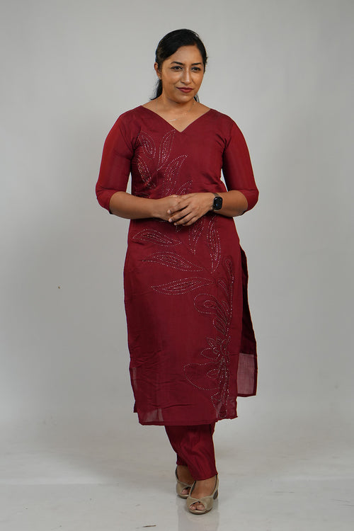 Woman wearing Aroha Ruby Grace maroon co-ord set with arms crossed
