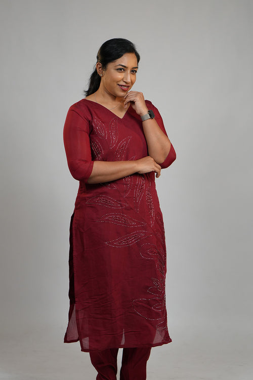 Woman in Aroha Ruby Grace maroon co-ord set looking down