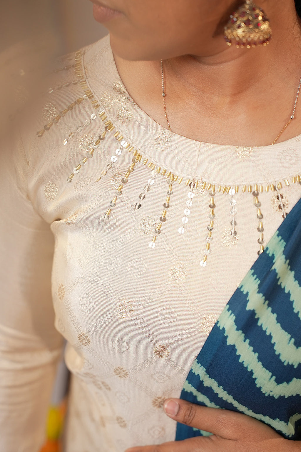 Close up of neckline detailing on Aroha Sea Breeze co-ord set with soft light flare