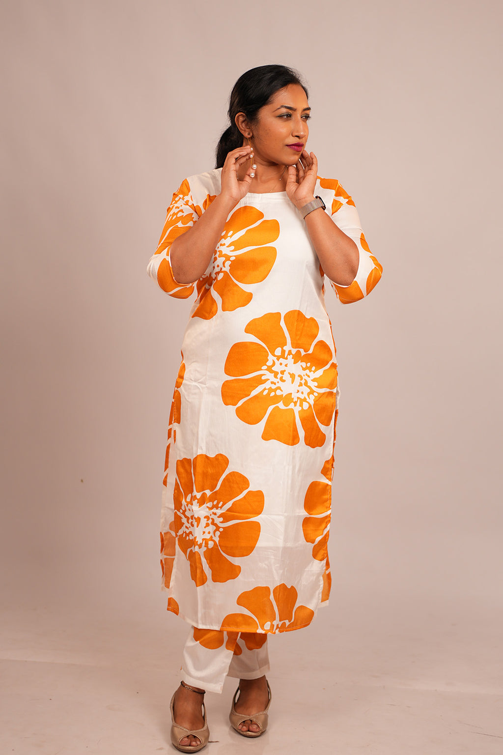 Woman in Aroha Sunflower white co-ord set looking away