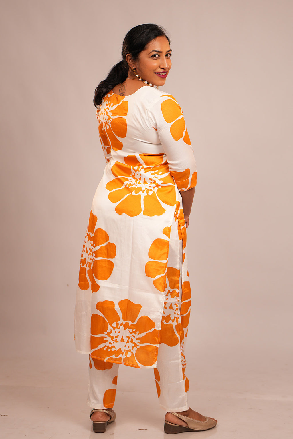 Woman in Aroha Sunflower co-ord set posing with an over the shoulder look